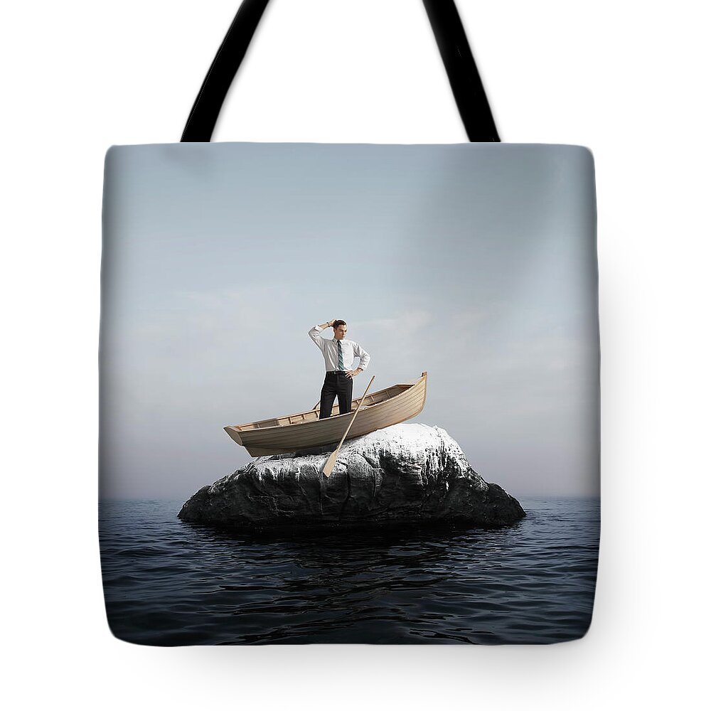 Problems Tote Bag featuring the photograph Man In Boat Stuck On A Rock by Stephen Swintek