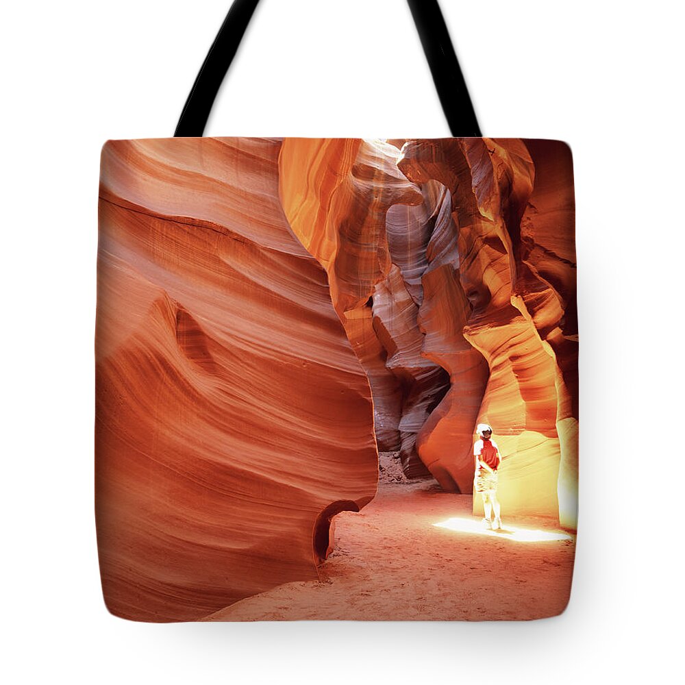 One Man Only Tote Bag featuring the photograph Man In Canyon In Sun Spot, Looking Up by Buena Vista Images