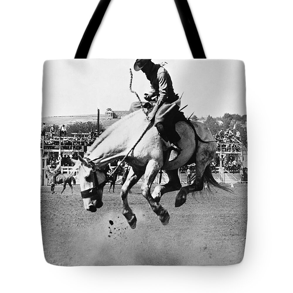 Man Riding Bucking Horse In Rodeo Tote Bag by Stockbyte 