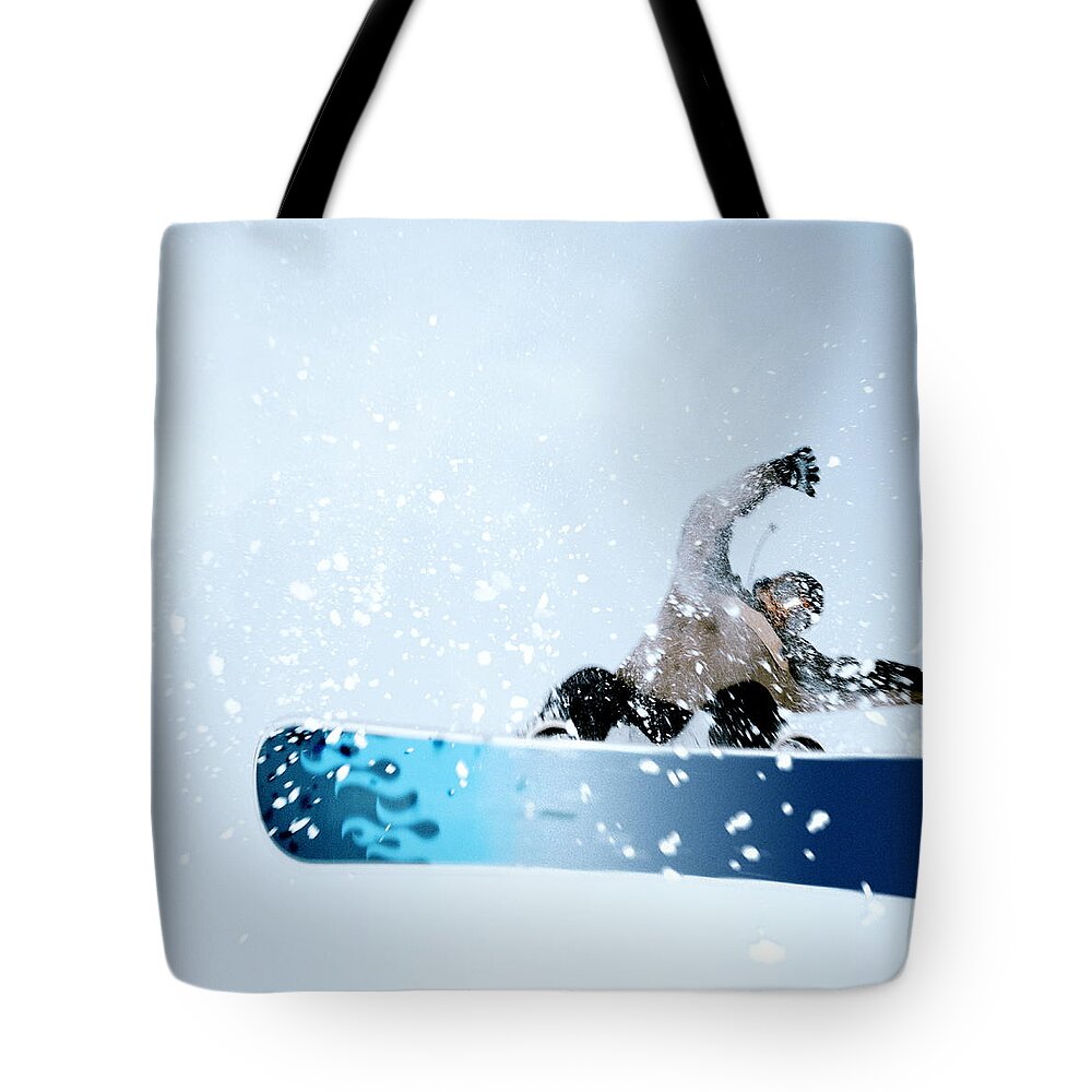 One Man Only Tote Bag featuring the photograph Man Snowboarding, Mid-jump. Low Angle by Martin Barraud