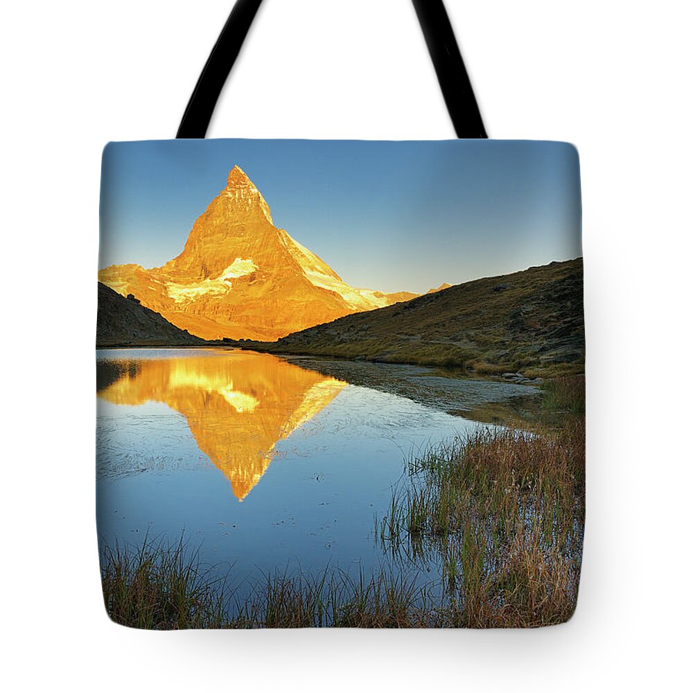 Scenics Tote Bag featuring the photograph Matterhorn Reflected In Riffelsee Lake by Cornelia Doerr