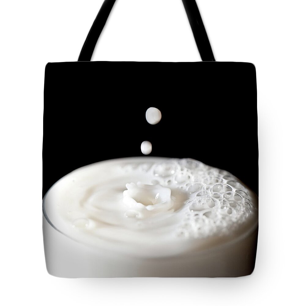 Milk Tote Bag featuring the photograph Milk Drops Falling In Glass Of Milk by Peter Chadwick Lrps