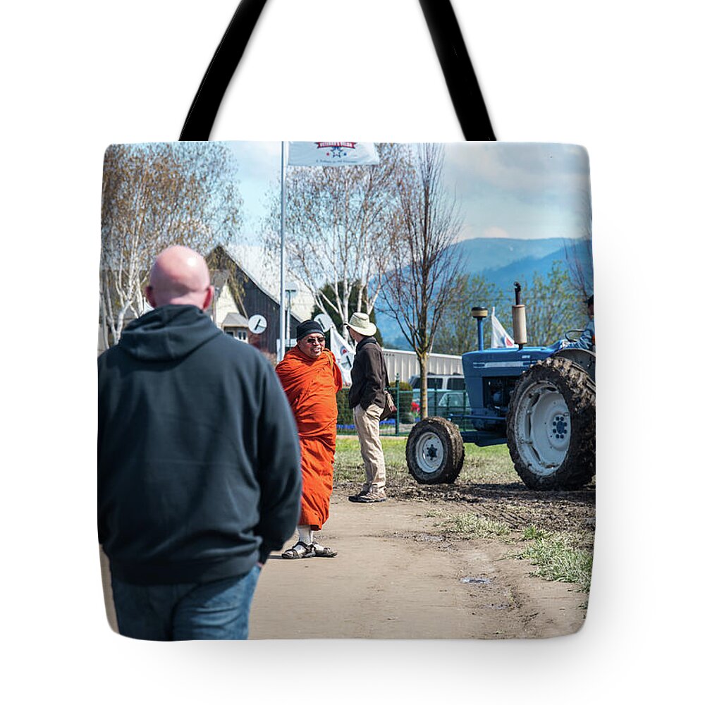 Monk And Tractor Tote Bag featuring the photograph Monk and Tractor by Tom Cochran