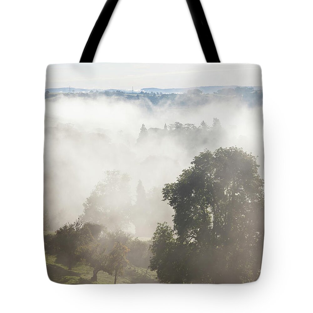 Tranquility Tote Bag featuring the photograph Morning Mist Over Abergavenny, South by Peter Adams