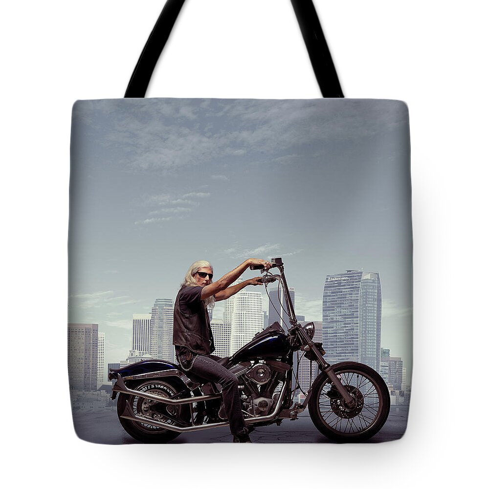 Mature Adult Tote Bag featuring the photograph Motorcycle Rider With City Background by Ed Freeman