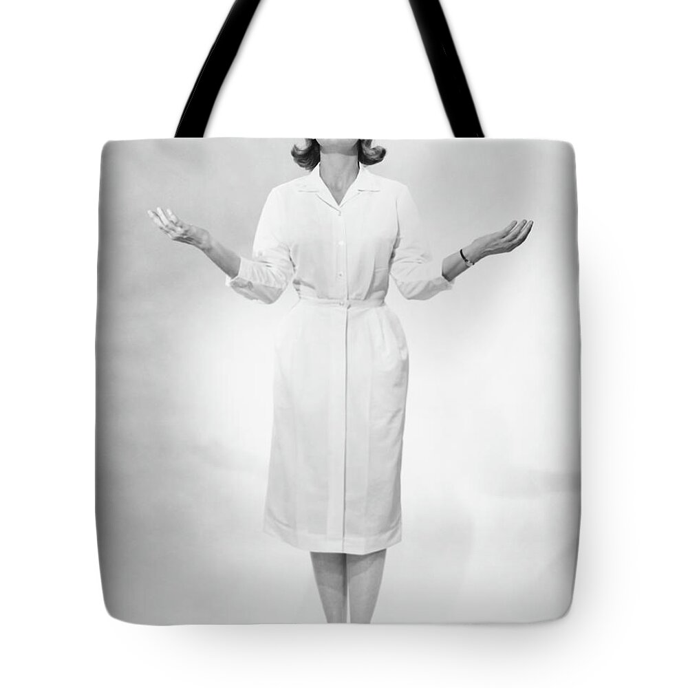Human Arm Tote Bag featuring the photograph Nurse Gesturing In Studio, B&w by George Marks