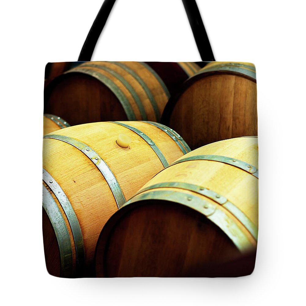 Alcohol Tote Bag featuring the photograph Oak Barrels For Maturing Wine At A by Rapideye