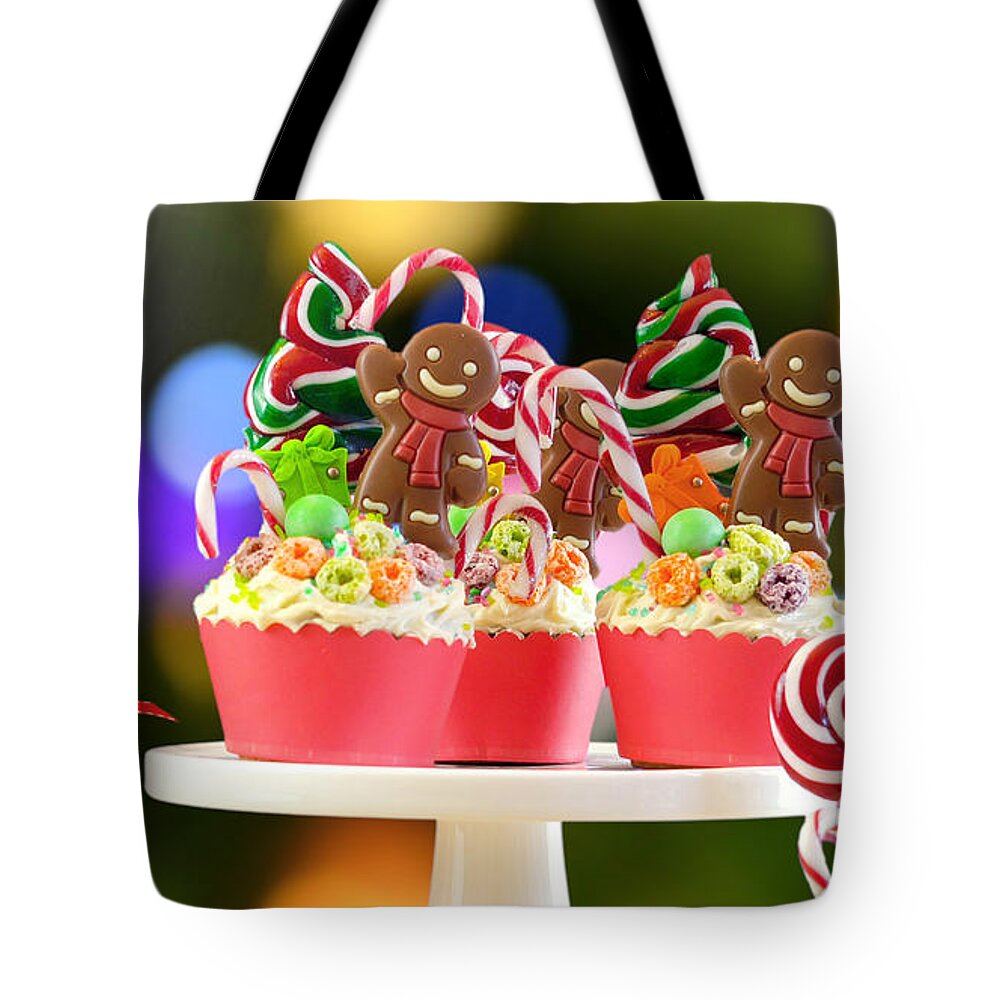Christmas Tote Bag featuring the photograph On trend candy land festive Christmas cupcakes. by Milleflore Images