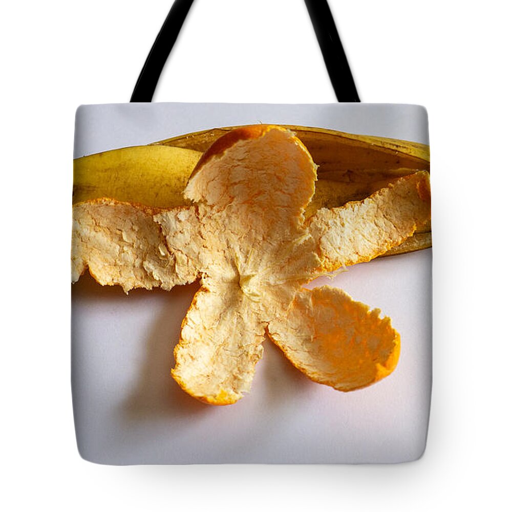 Orange Tote Bag featuring the photograph Orange on Banana by Ivars Vilums