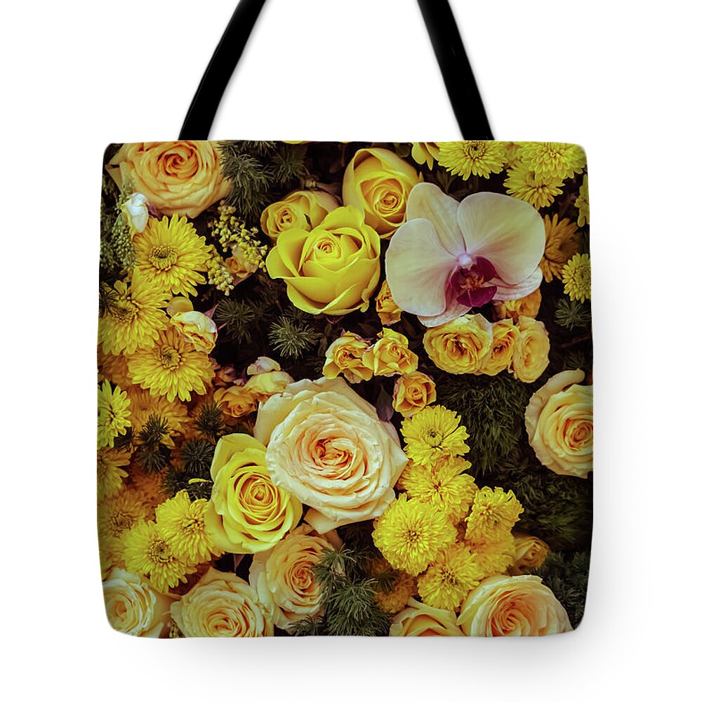 Outdoors Tote Bag featuring the photograph Orchid among Yellow Roses by Silvia Marcoschamer