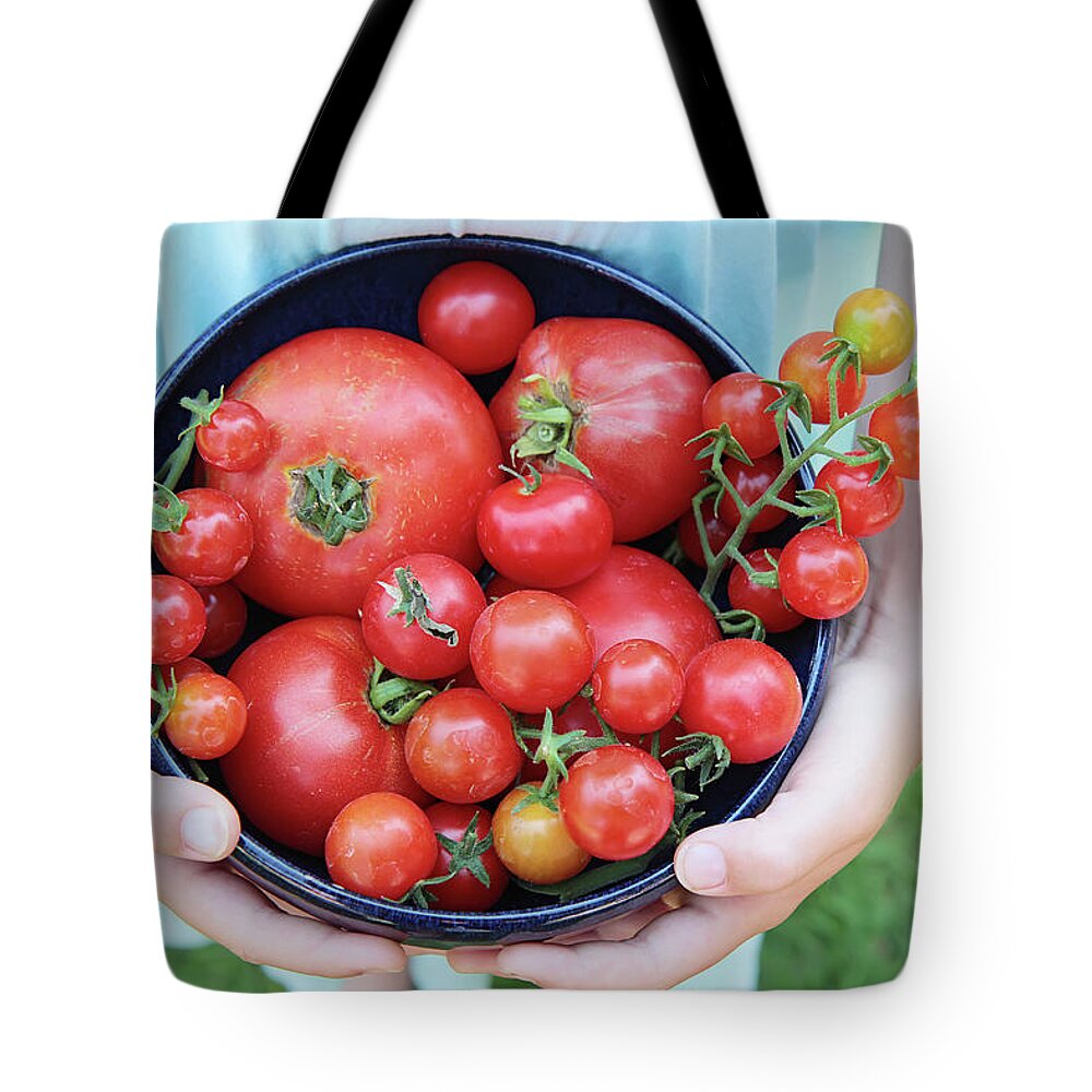 Grass Tote Bag featuring the photograph Organic Home Grown Tomatoes Held By Girl by Dianne Avery Photography