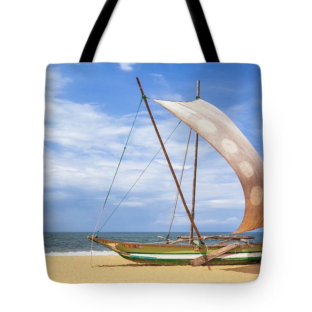 Wind Tote Bag featuring the photograph Outrigger Prahu Or Proa On The Beach In by Cinoby