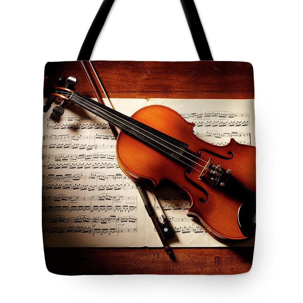 Sheet Music Tote Bag featuring the photograph Overhead View Of A Violin And Music by Wragg