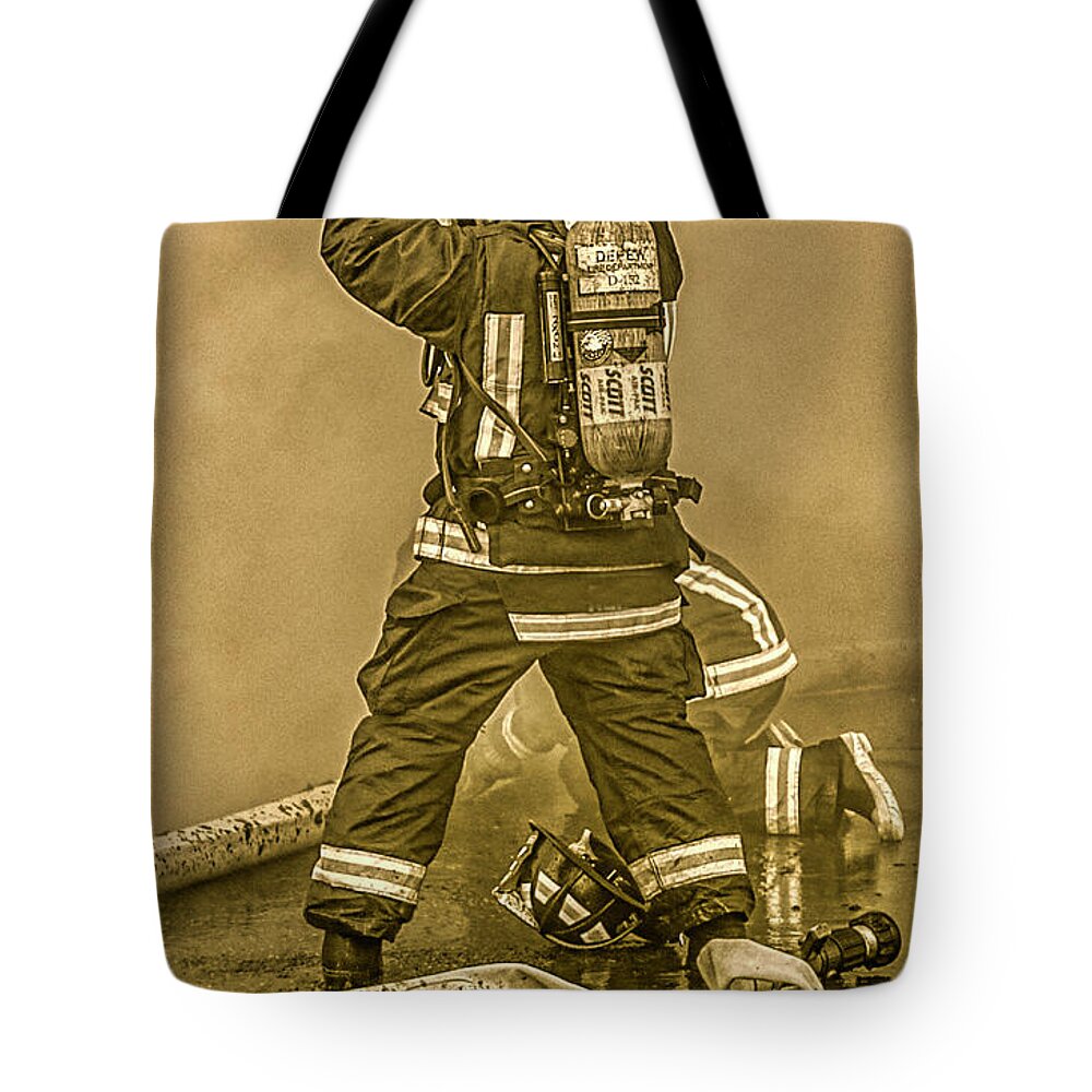 Getting Ready For Battle #fire #firefighter #firefighters #brotherhood #tradition #firephoto #smoke #scba #workingfire #instagood #firemen #fireman #firechief #instagramphotos #photography #photographer #instagram #picoftheday #imageoftheday #photo #hdr #highdynamicrange #skylum #aurorahdr2019  Tote Bag featuring the photograph Packing Up by Jim Lepard