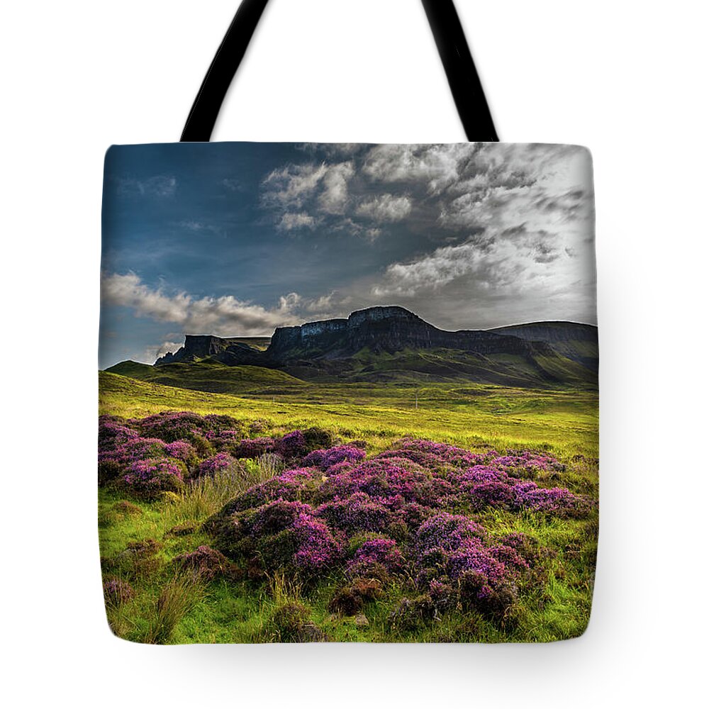 Abandoned Tote Bag featuring the photograph Pasture With Blooming Heather In Scenic Mountain Landscape At The Old Man Of Storr Formation On The by Andreas Berthold