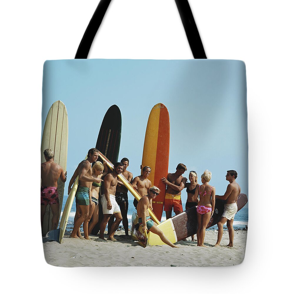 People Tote Bag featuring the photograph People On Beach With Surf Board by Tom Kelley Archive