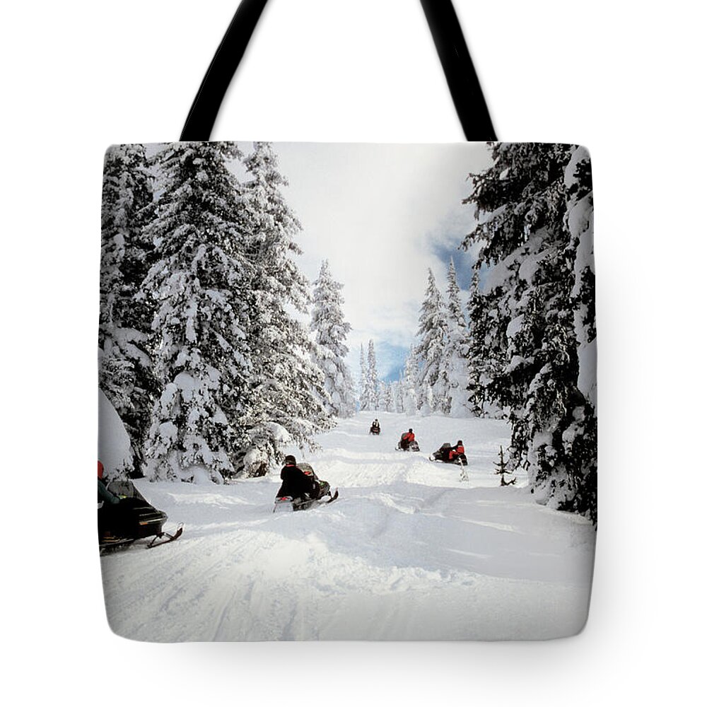 People Tote Bag featuring the photograph People On Snowmobiles In Yellowstone by Medioimages/photodisc