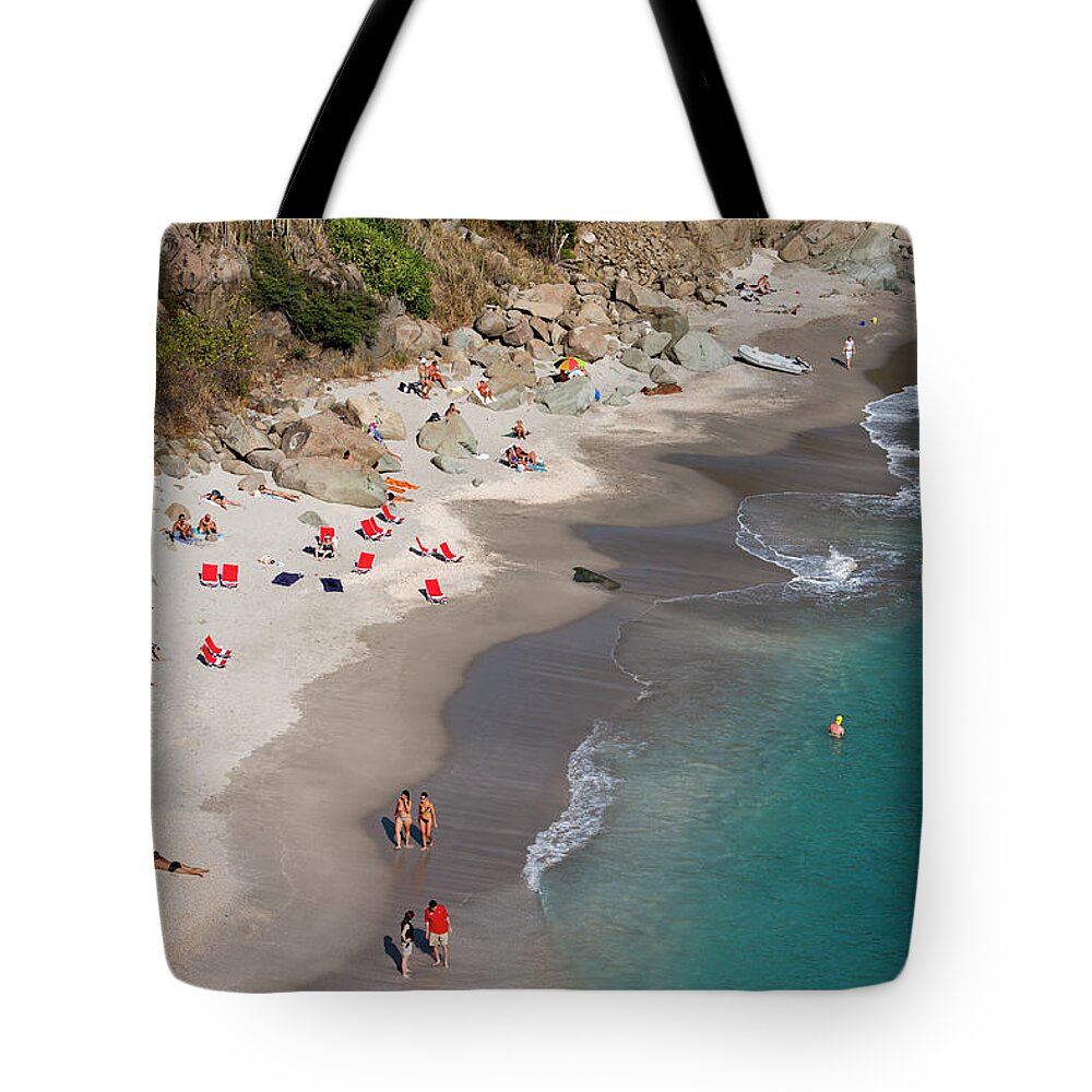 Water's Edge Tote Bag featuring the photograph People Relax On Shell Beach by Holger Leue