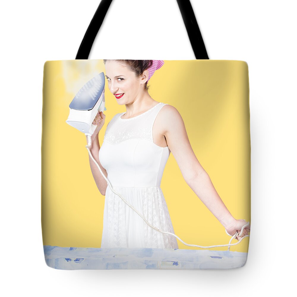 Cleaning Tote Bag featuring the photograph Pin up woman providing steam clean ironing service by Jorgo Photography