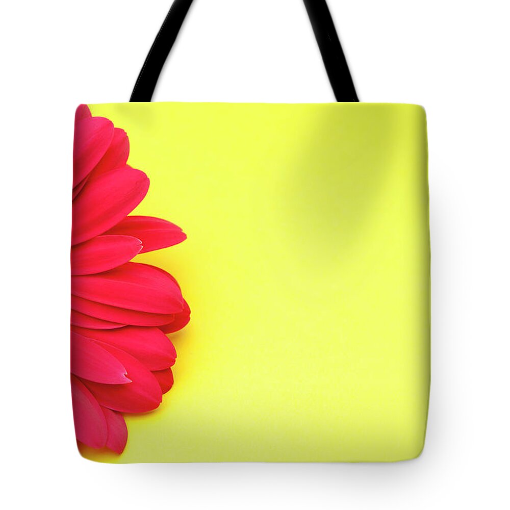 Petal Tote Bag featuring the photograph Pink Gerbera Daisy On Yellow Background by Jill Fromer
