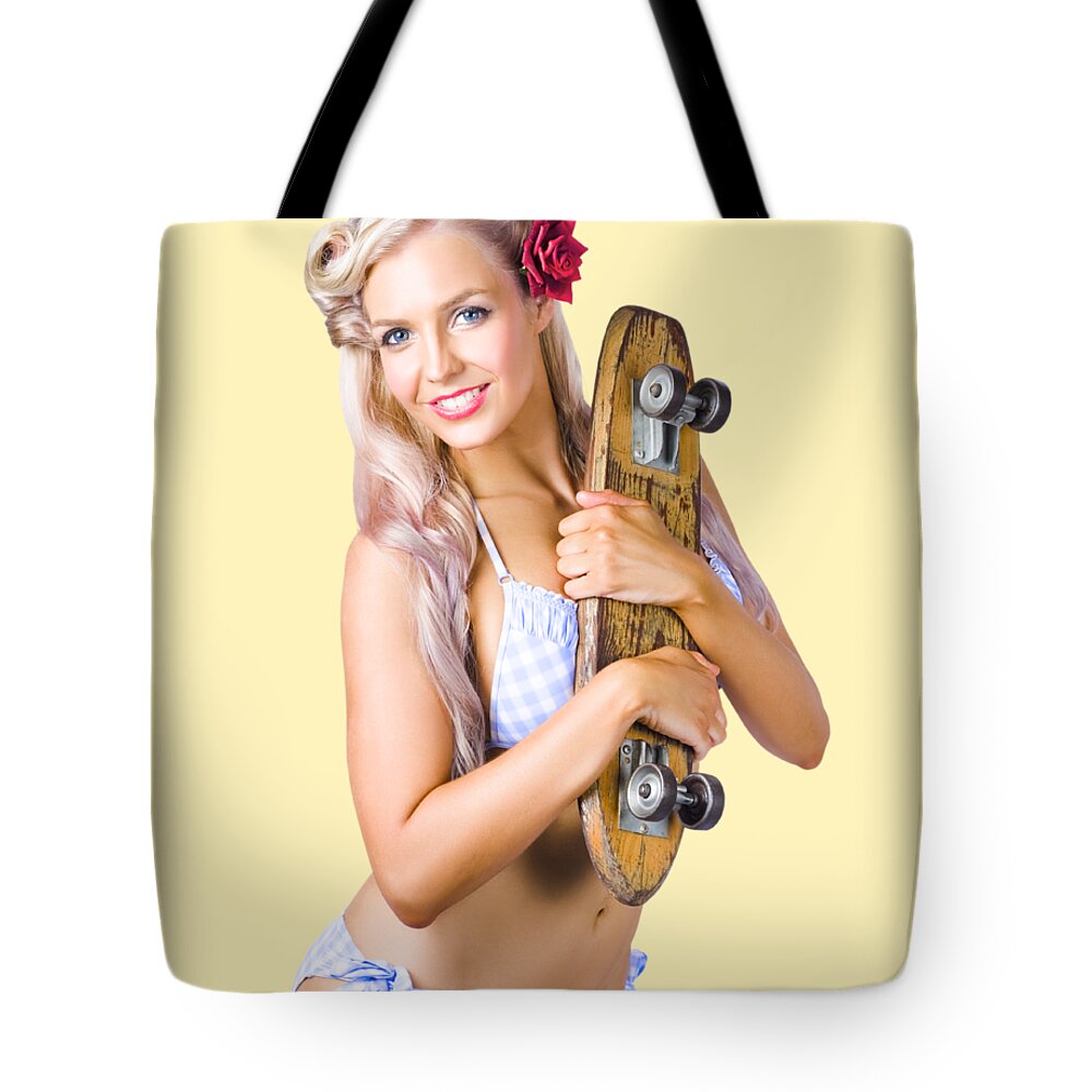 Skate Tote Bag featuring the photograph Pinup woman in bikini holding skateboard by Jorgo Photography