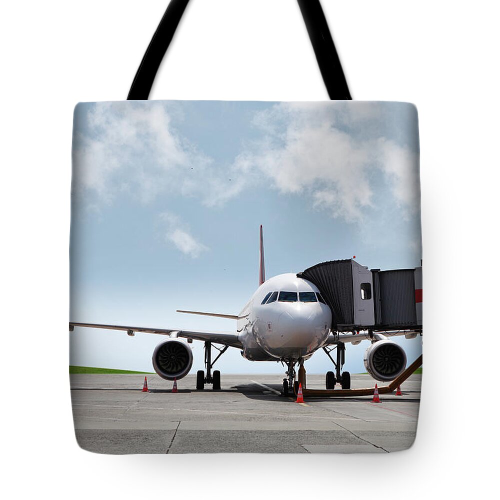 Passenger Boarding Bridge Tote Bag featuring the photograph Plane At The Gate by Xefstock