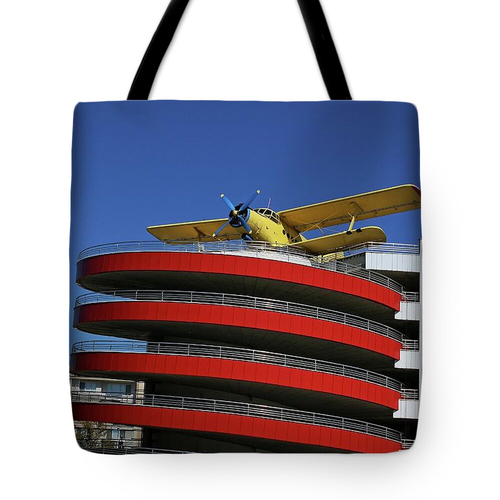 Plane Tote Bag featuring the photograph Plane on building by Martin Smith