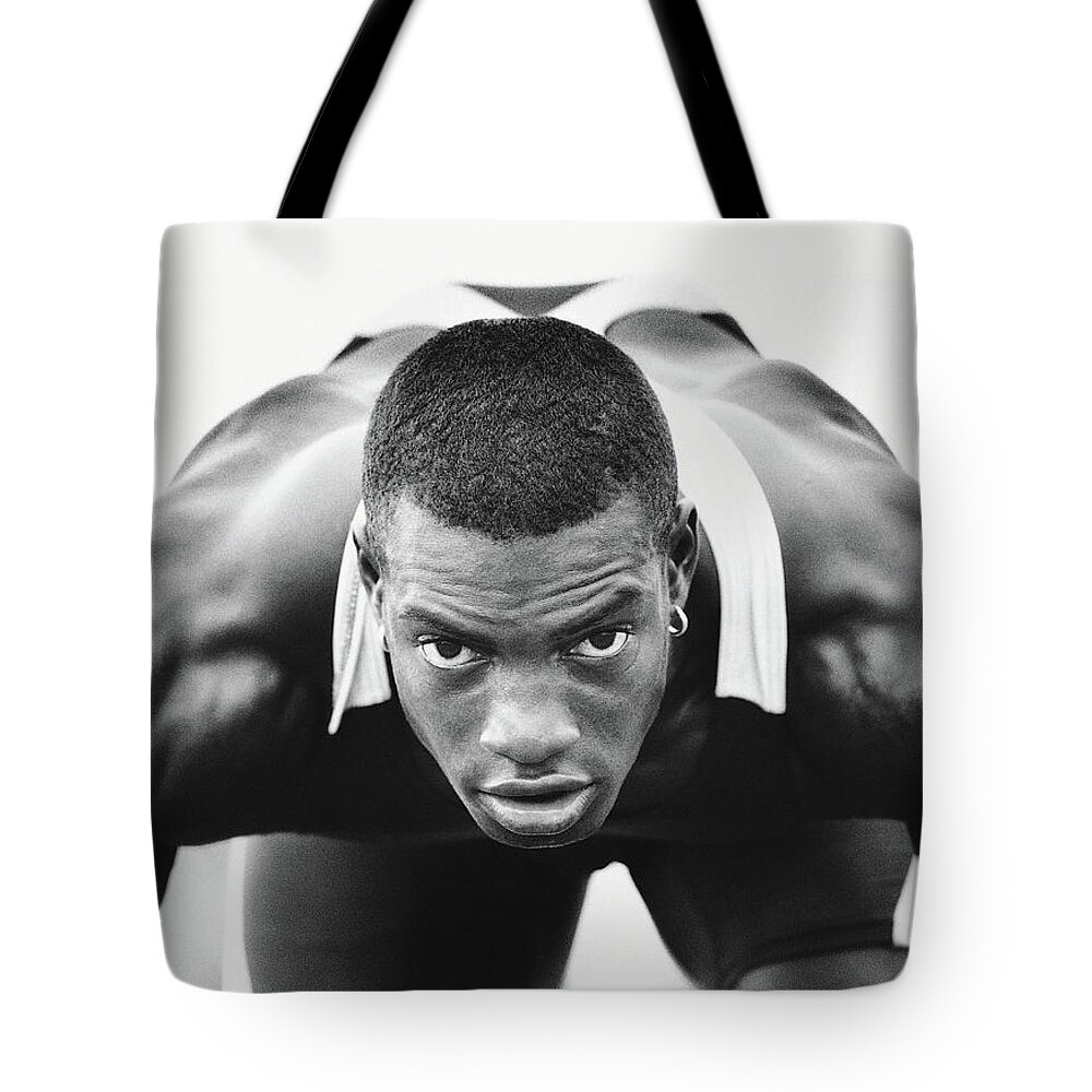 One Man Only Tote Bag featuring the photograph Portrait Of Determined Runner by Digital Vision.