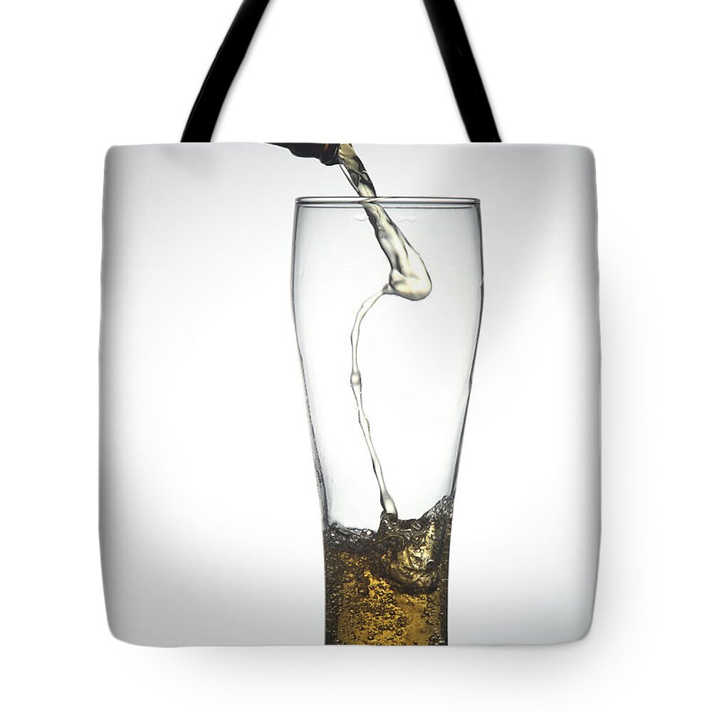 White Background Tote Bag featuring the photograph Pouring Beer by Fotografiabasica