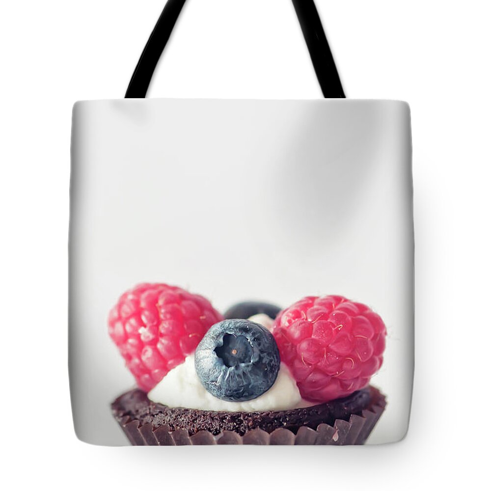 Unhealthy Eating Tote Bag featuring the photograph Raspberries And Blueberries Cupcake by Marta Nardini