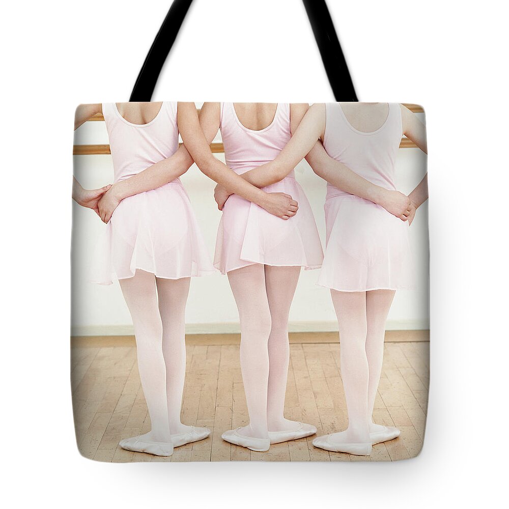 Ballet Dancer Tote Bag featuring the photograph Rear View Of Three Young Ballet Dancers by Digital Vision.
