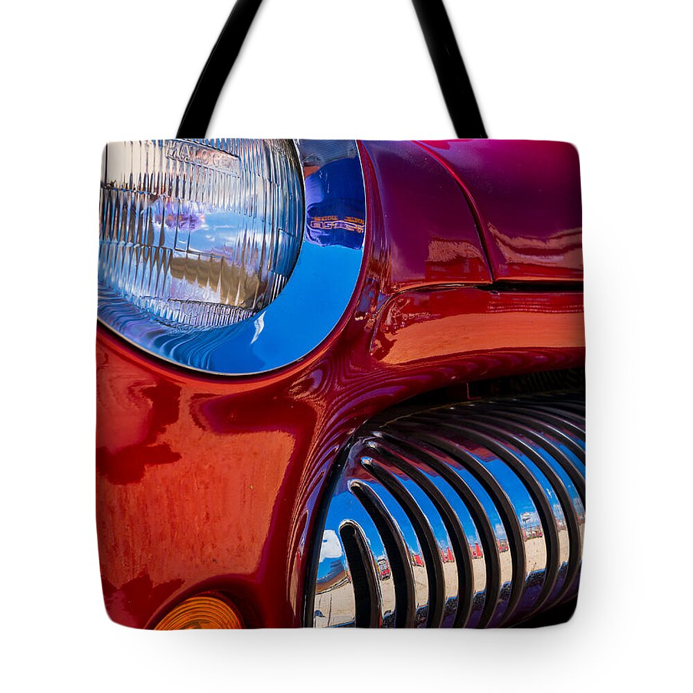 Red Tote Bag featuring the photograph Red Car Chrome Grill by Tom Gresham