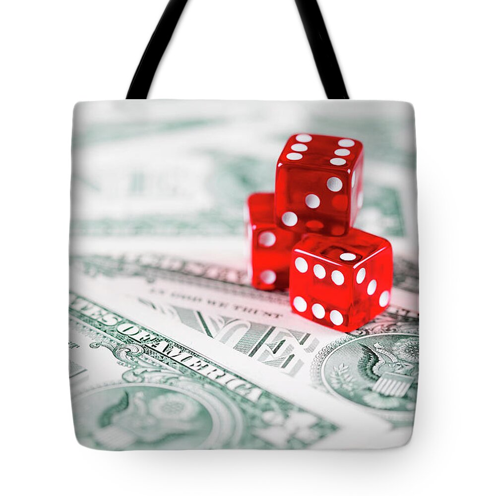 Risk Tote Bag featuring the photograph Red Dice On Us Dollar Bills by Neil Overy