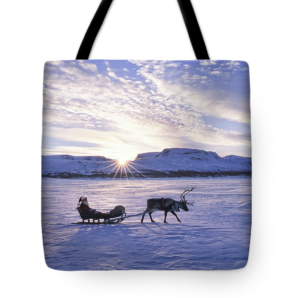 One Man Only Tote Bag featuring the photograph Reindeer Pulling Santa On Sled Over by Per Breiehagen