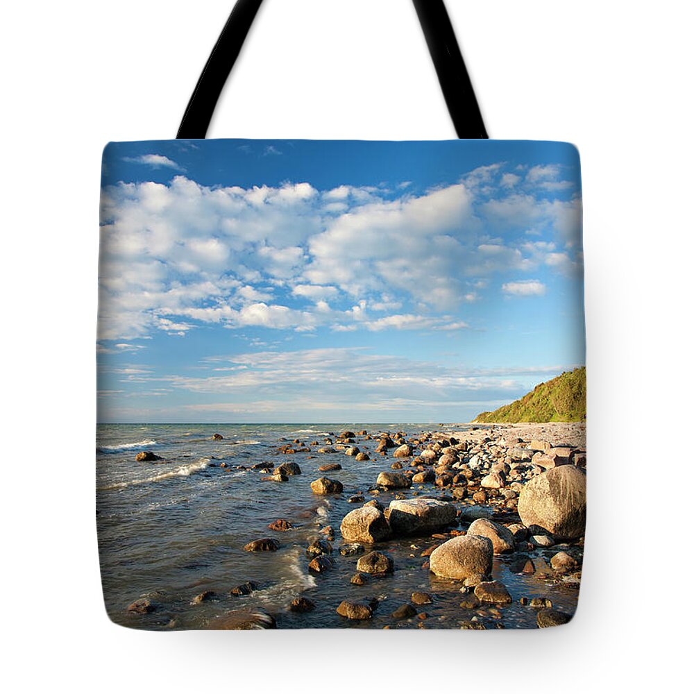 Water's Edge Tote Bag featuring the photograph Rocky Coastline With Boulders In Warm by Avtg