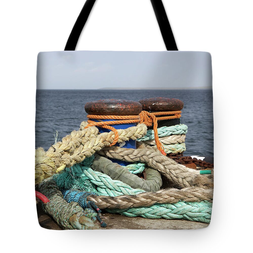 Scotland Tote Bag featuring the photograph Ropes Tied Around Metal Bollards In A by Joe Fox