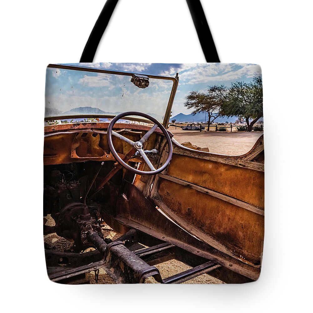 Car Tote Bag featuring the photograph Rusty car leftovers by Lyl Dil Creations