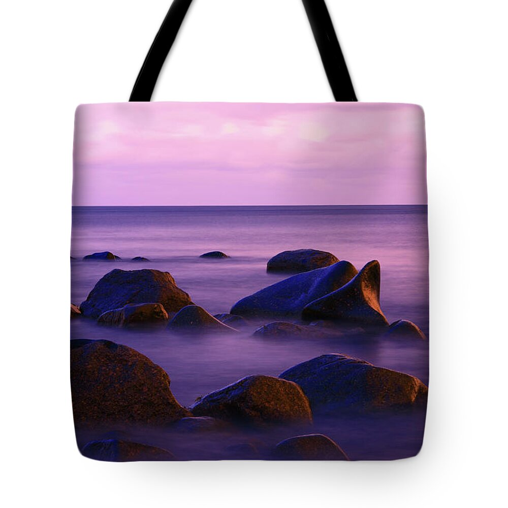 Water's Edge Tote Bag featuring the photograph Seascape With Some Rocks Protruding The by Imaginegolf