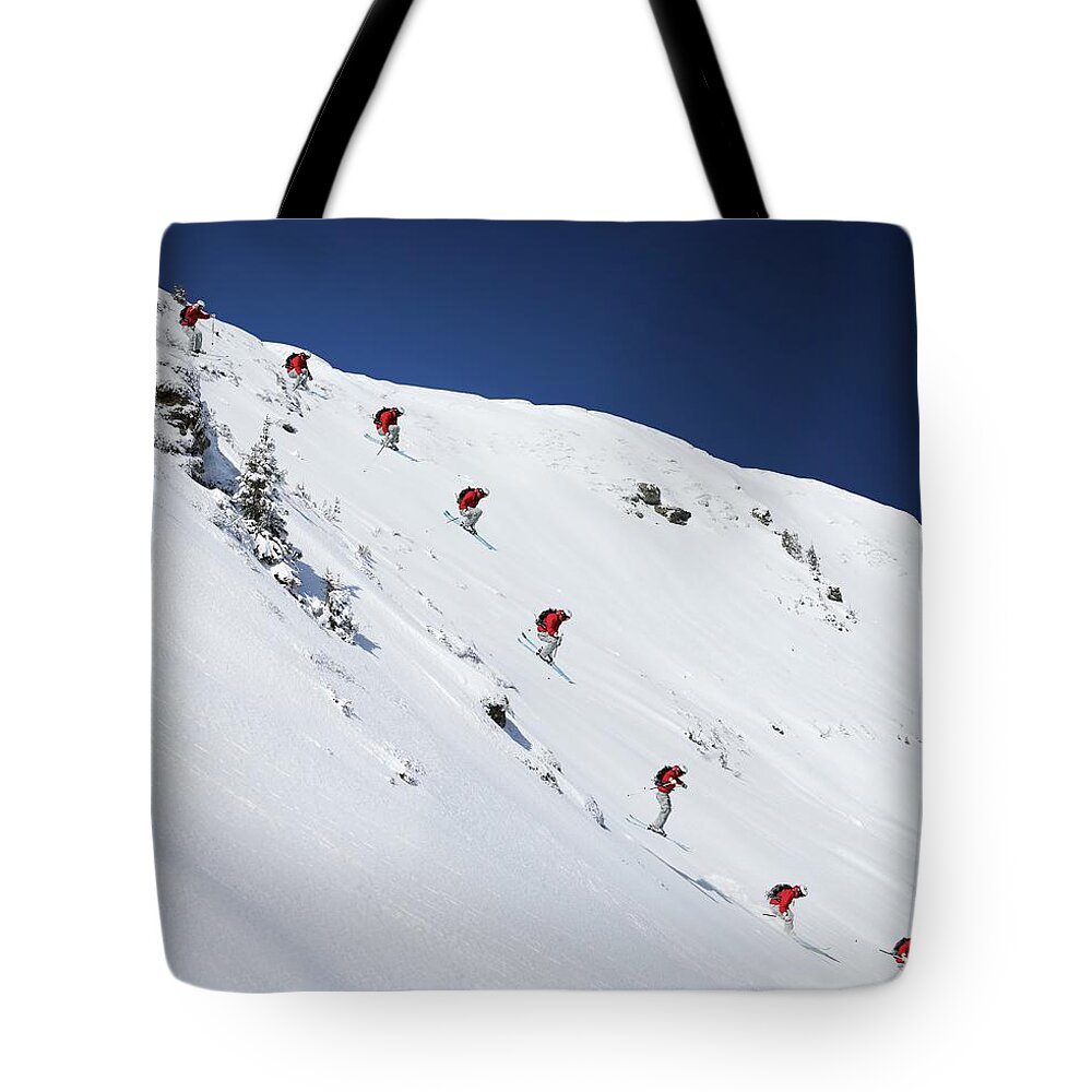 Skiing Tote Bag featuring the photograph Sequence Of Male Skier Jumping Down by Adie Bush