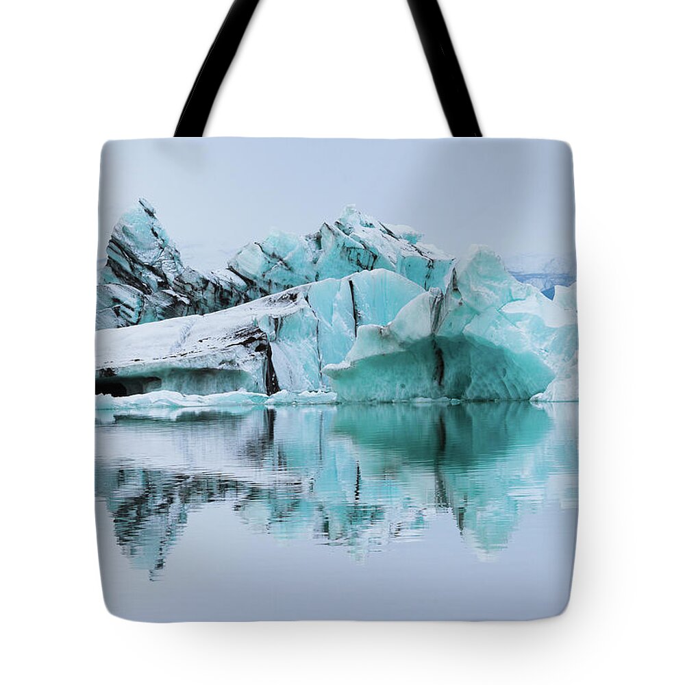 Tranquility Tote Bag featuring the photograph Silt-streaked Icebergs At Jökulsárlón by Anna Gorin