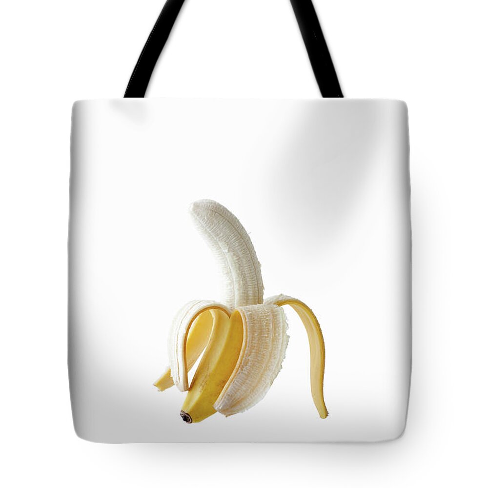 White Background Tote Bag featuring the photograph Skin Of Banana Peeled Off Half by Michael H