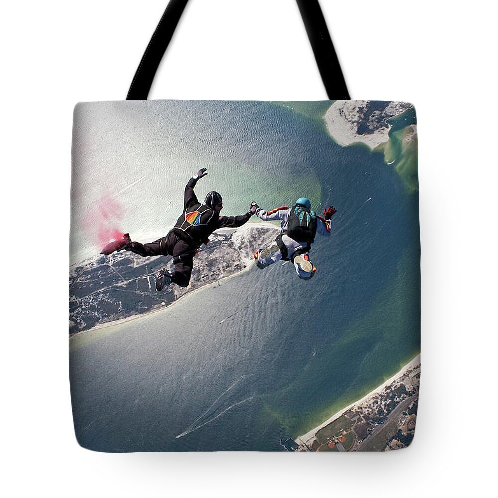 Mature Adult Tote Bag featuring the photograph Skydivers In Freefall Over Nas Pensacola by Kevin Elvis King