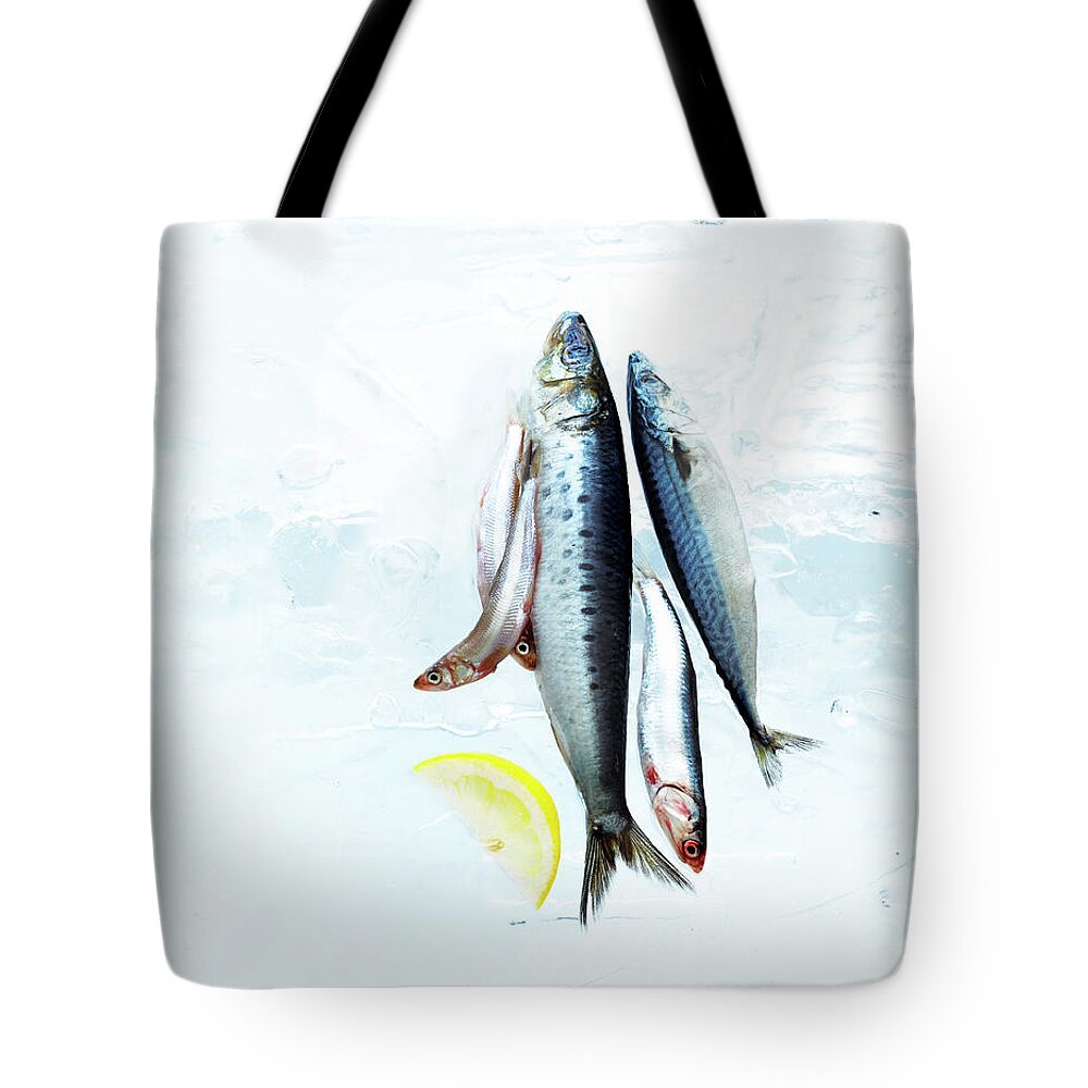 White Background Tote Bag featuring the photograph Small Fish On Block Of Ice With Lemon by Annabelle Breakey