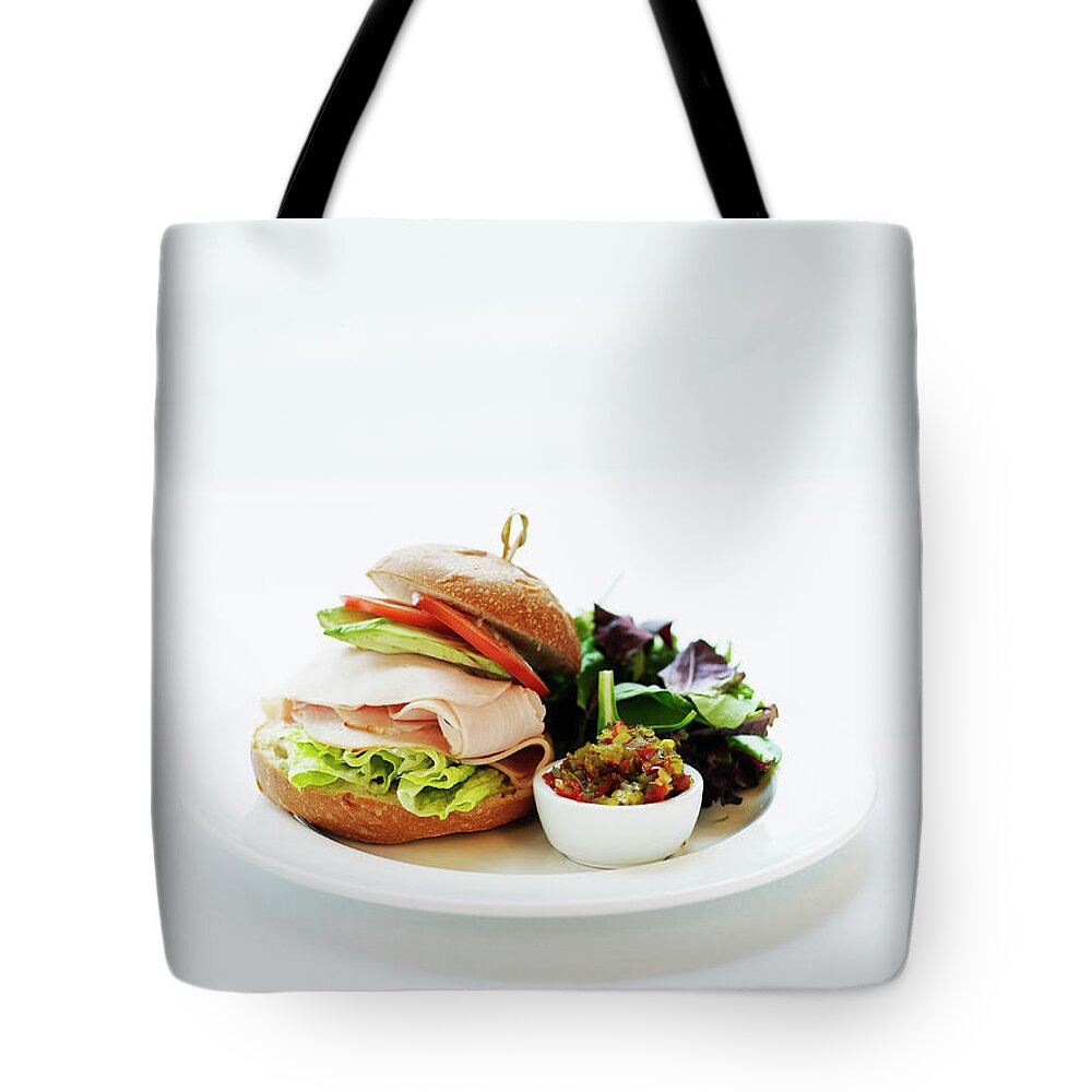 Breakfast Tote Bag featuring the photograph Smoked Turkey Sandwich Served On A by Thomas Barwick