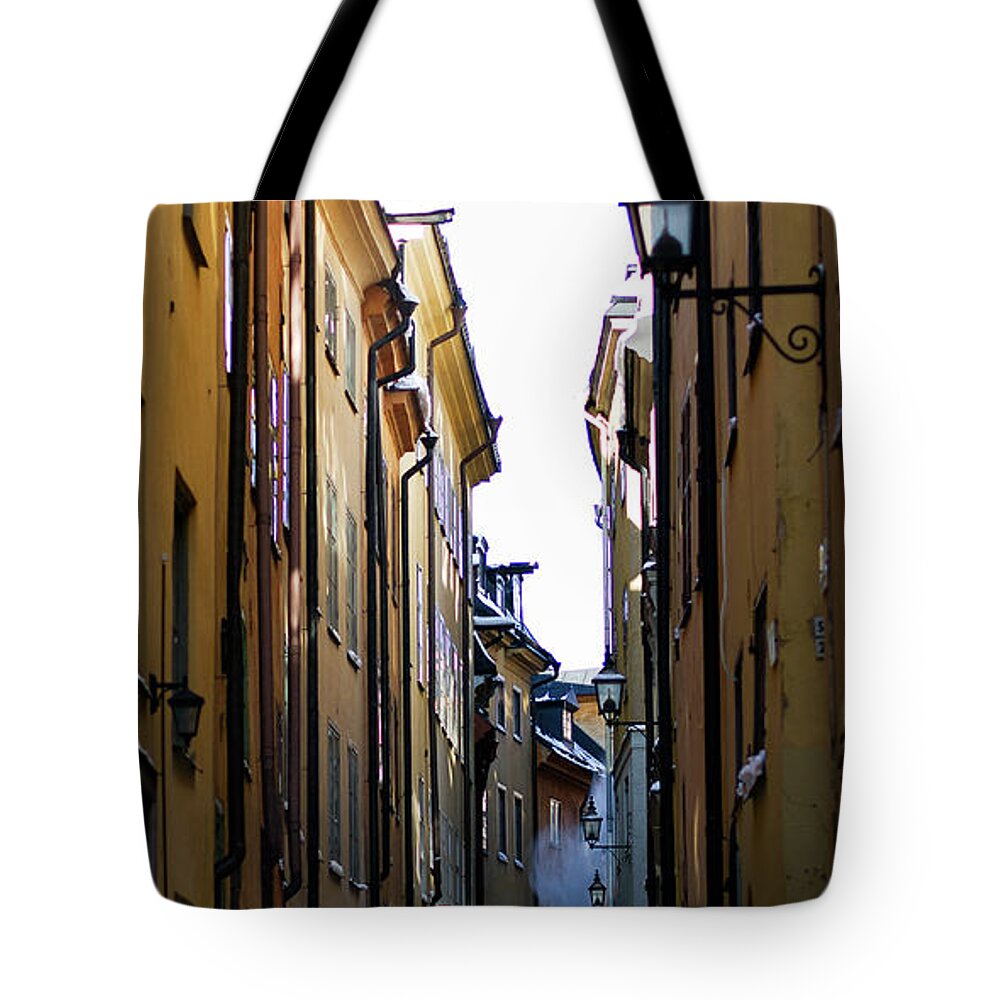 Tranquility Tote Bag featuring the photograph Snow Falling Off Roofs In Stockholms by Johan Klovsjö