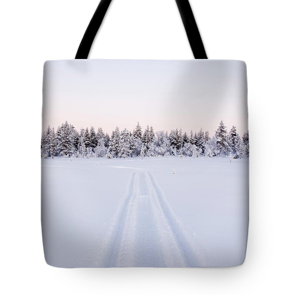 Extreme Terrain Tote Bag featuring the photograph Snow-topped Forest With Snowmobile by Juhokuva