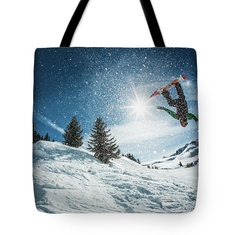 People Tote Bag featuring the photograph Snowboarder Doing A Backflip With Snow by © Francois Marclay