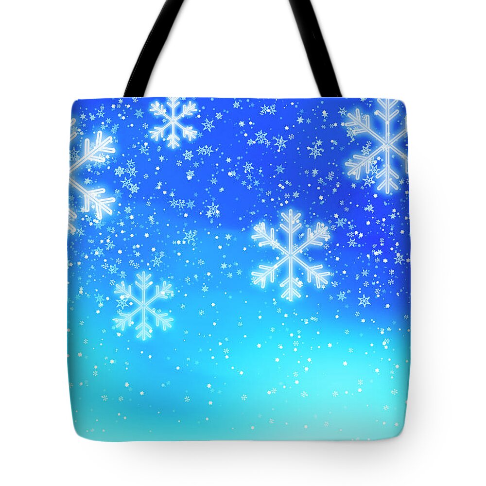 Backgrounds Tote Bag featuring the photograph Snowflakes On Blue Background, Studio by Tetra Images
