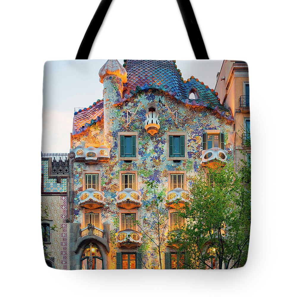 Estock Tote Bag featuring the digital art Spain, Catalonia, Barcelona, Casa Batllo Illuminated At Dusk , Architect Antoni Gaudi by Jordan Banks