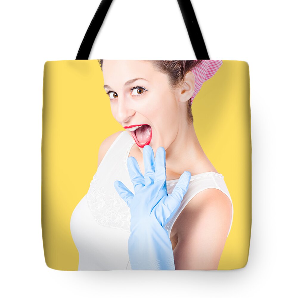 Pinup Tote Bag featuring the photograph Stunned cleaning house wife wearing rubber glove by Jorgo Photography